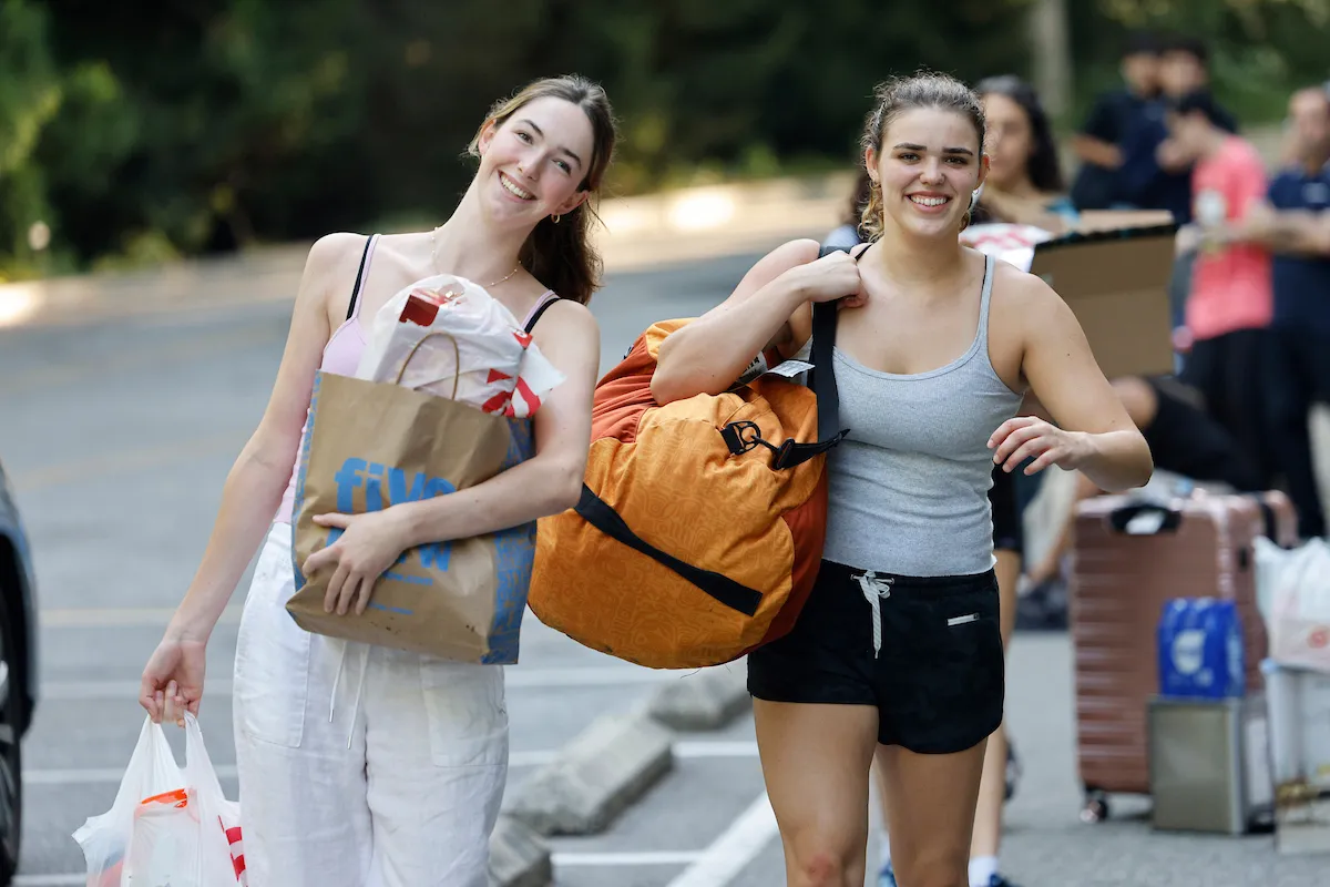 Students carry items during move-in day