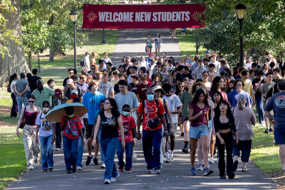 Parents and students walk down Magill walk