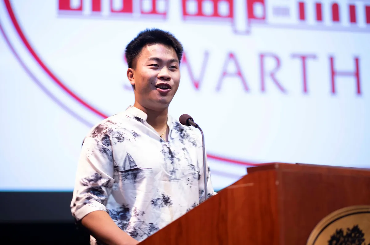 Student speaker at podium during orientation event