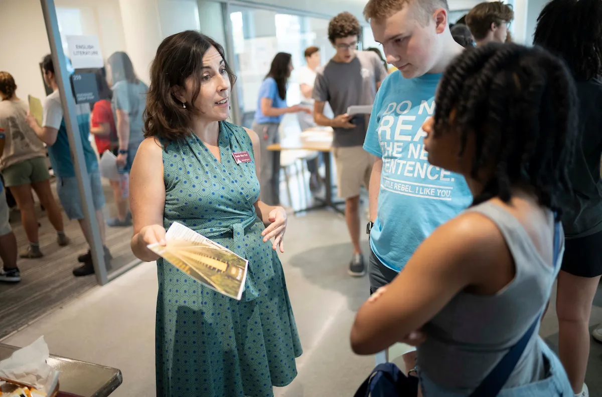 Professor speaks with student during academic advising fair