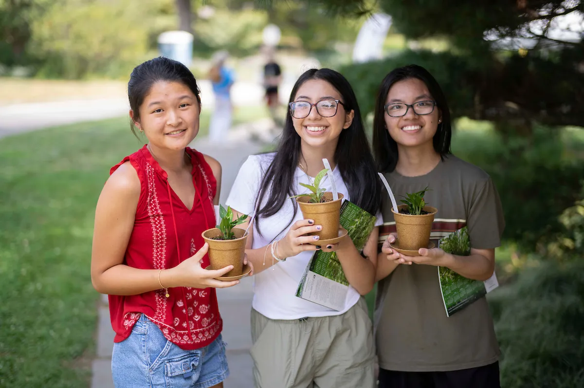 Students posed with potted plants