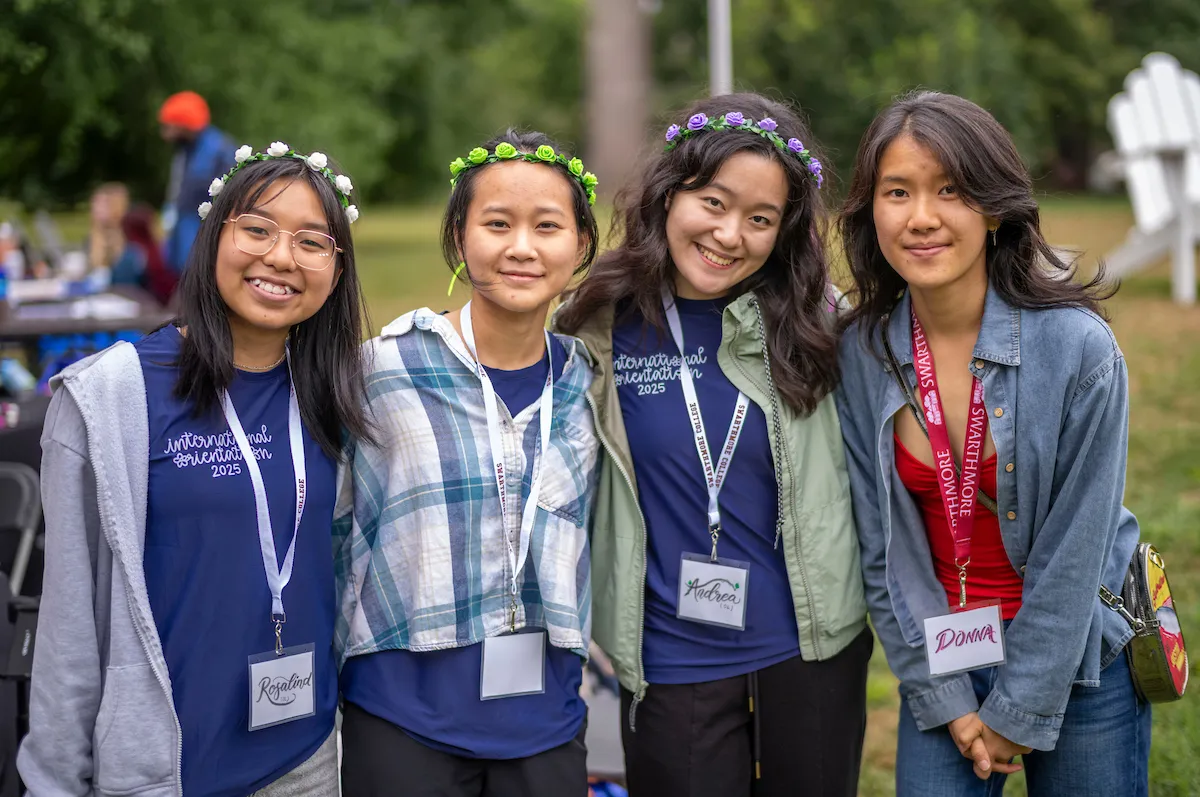 Group of four international students pose for picture