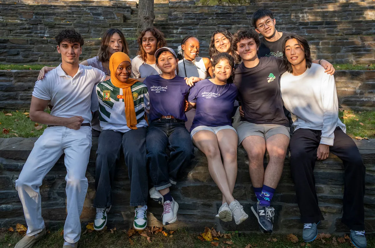 Group of international students pose in outdoor amphitheater