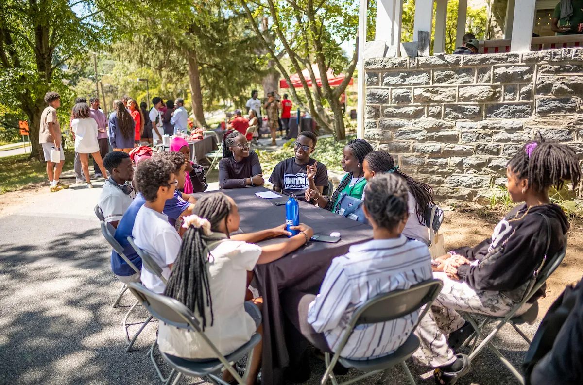 Students sit at table during welcome event at Black Cultural Center