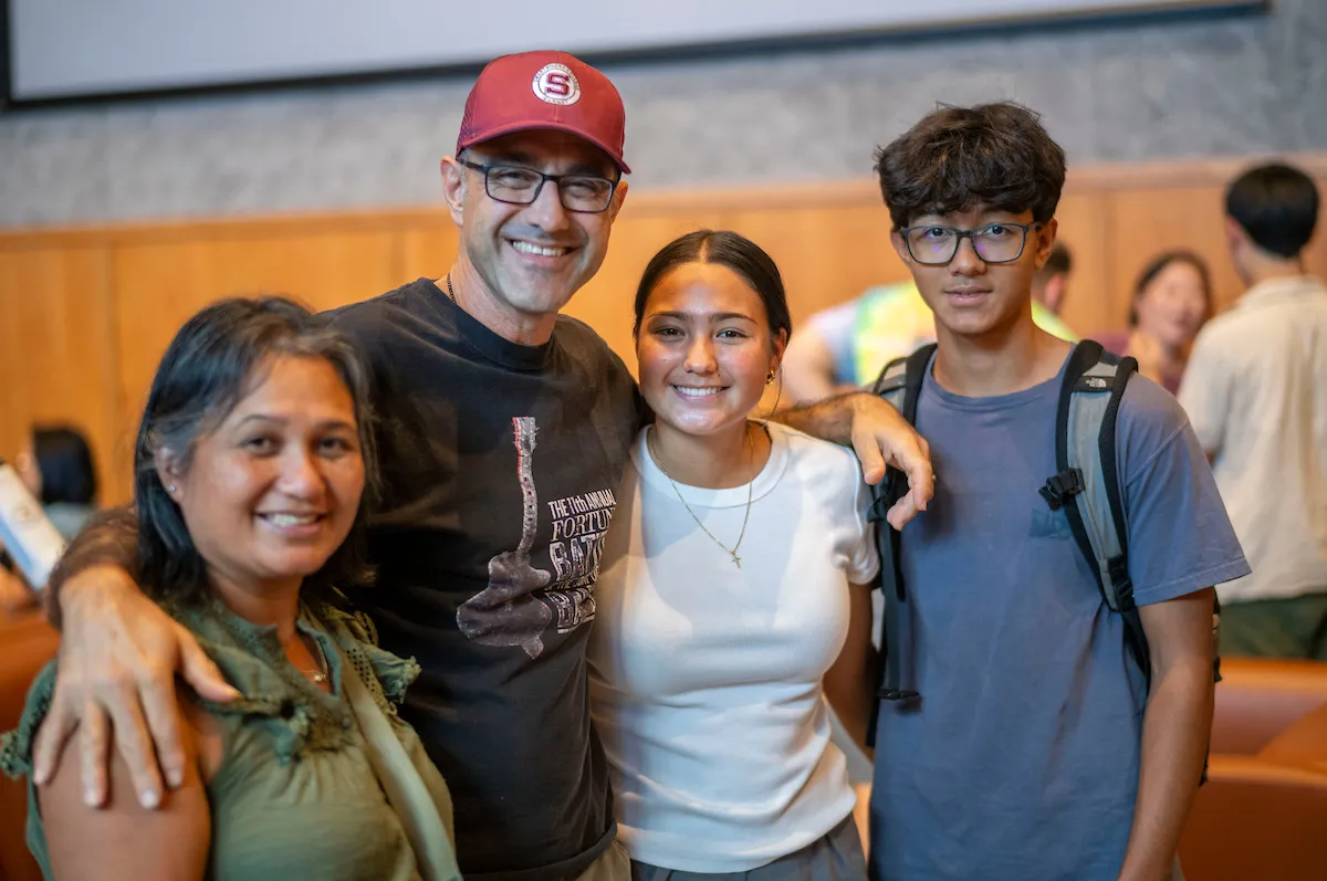 Family poses with student during orientation event