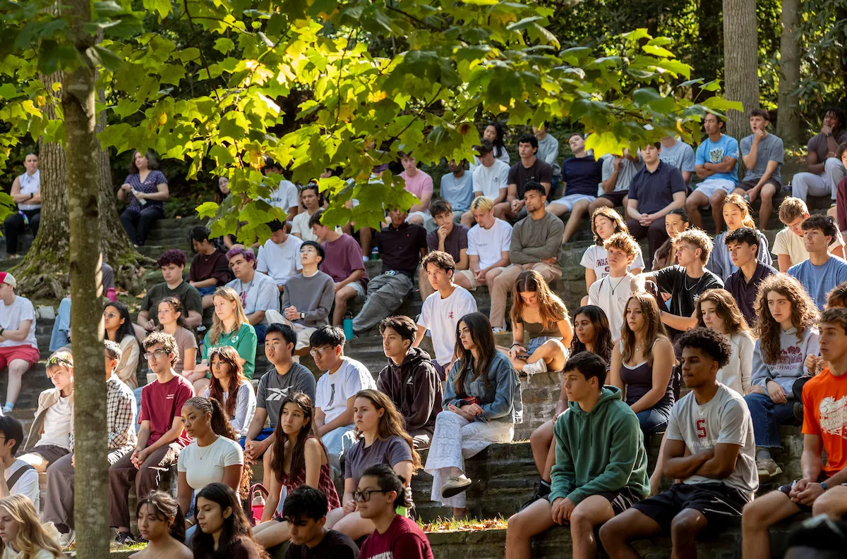 Students sit in outdoor amphitheater