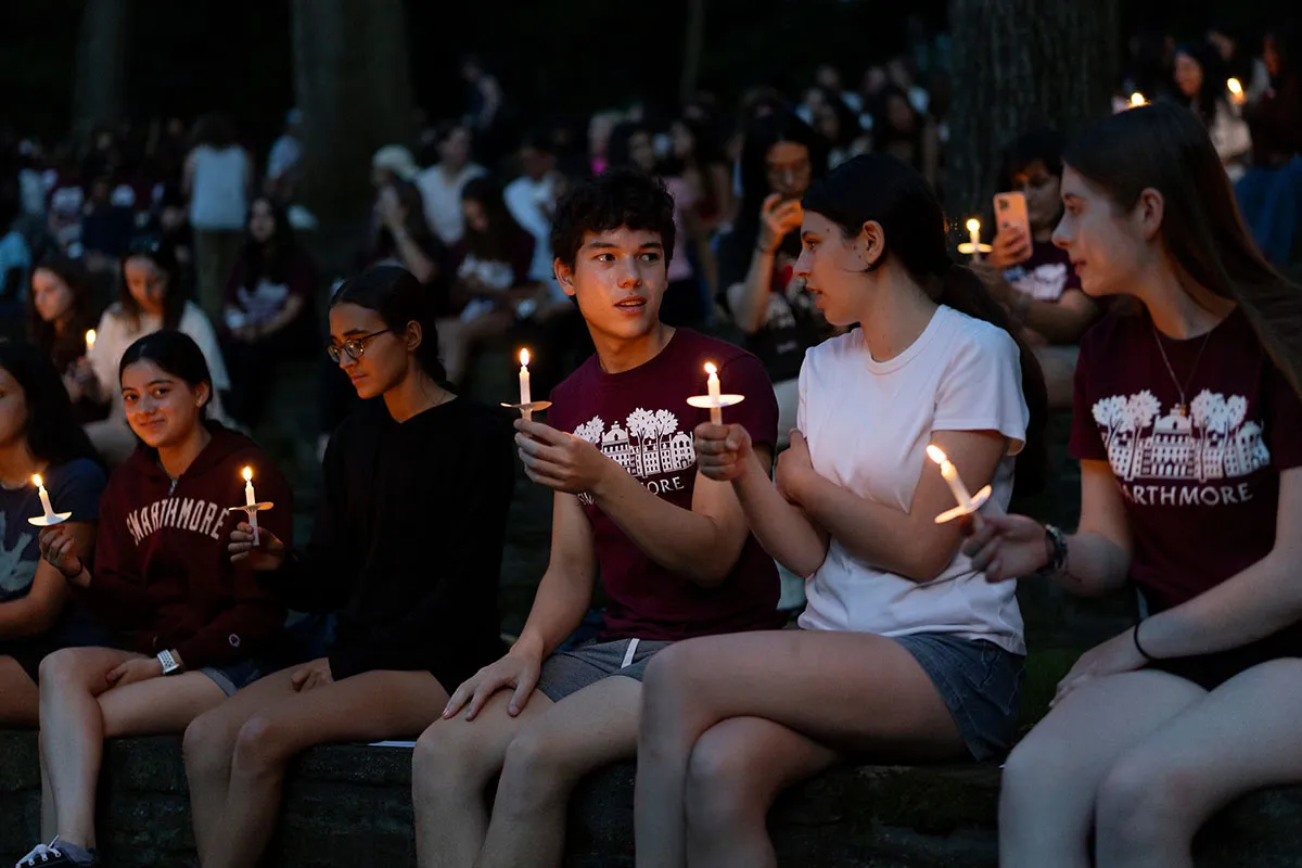 Students hold candles at first collection