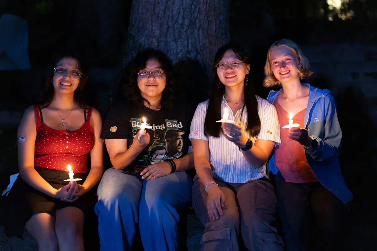 Students hold candles at first collection in Scott Outdoor amphitheater
