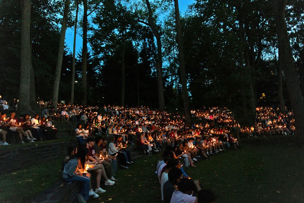 Students hold candles at first collection in Scott Outdoor amphitheater