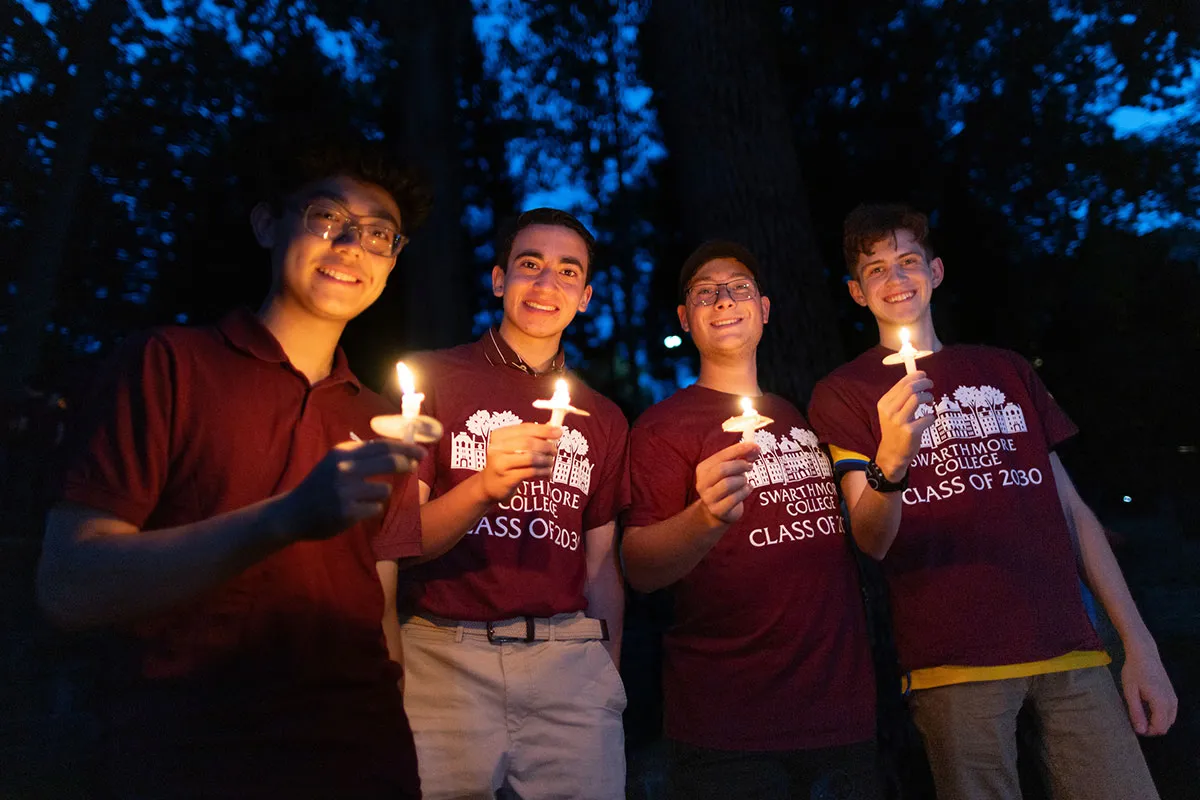 Students hold candles at first collection in Scott Outdoor amphitheater