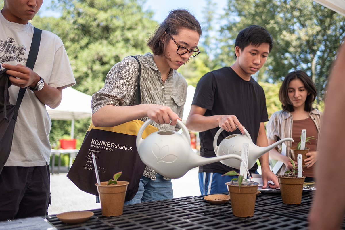 Students water plants at arboretum giveaway event