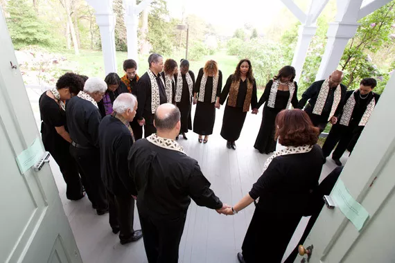 Members of the choir hold hands
