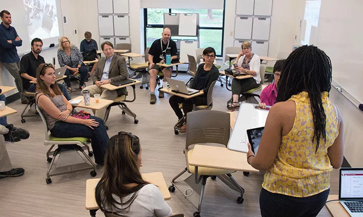 People sit in a newly renovated classroom