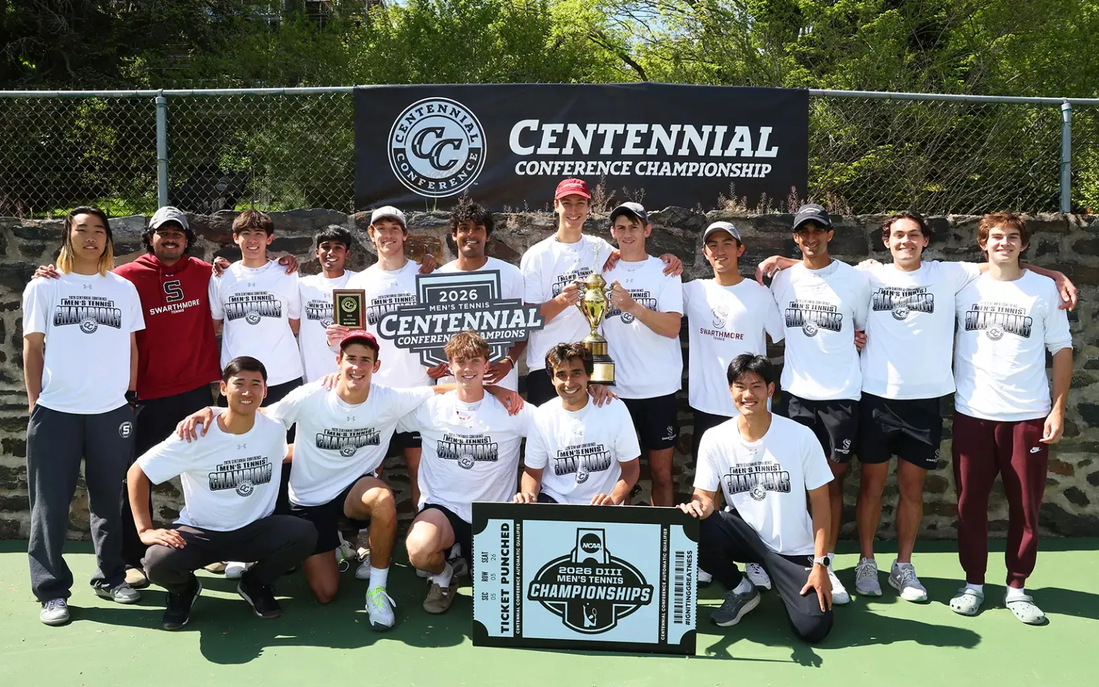 men's tennis team celebrates conference title with trophy