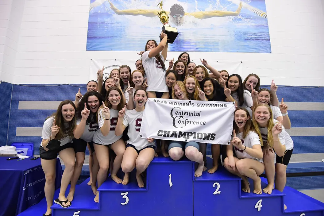 Women's swimming team with trophy