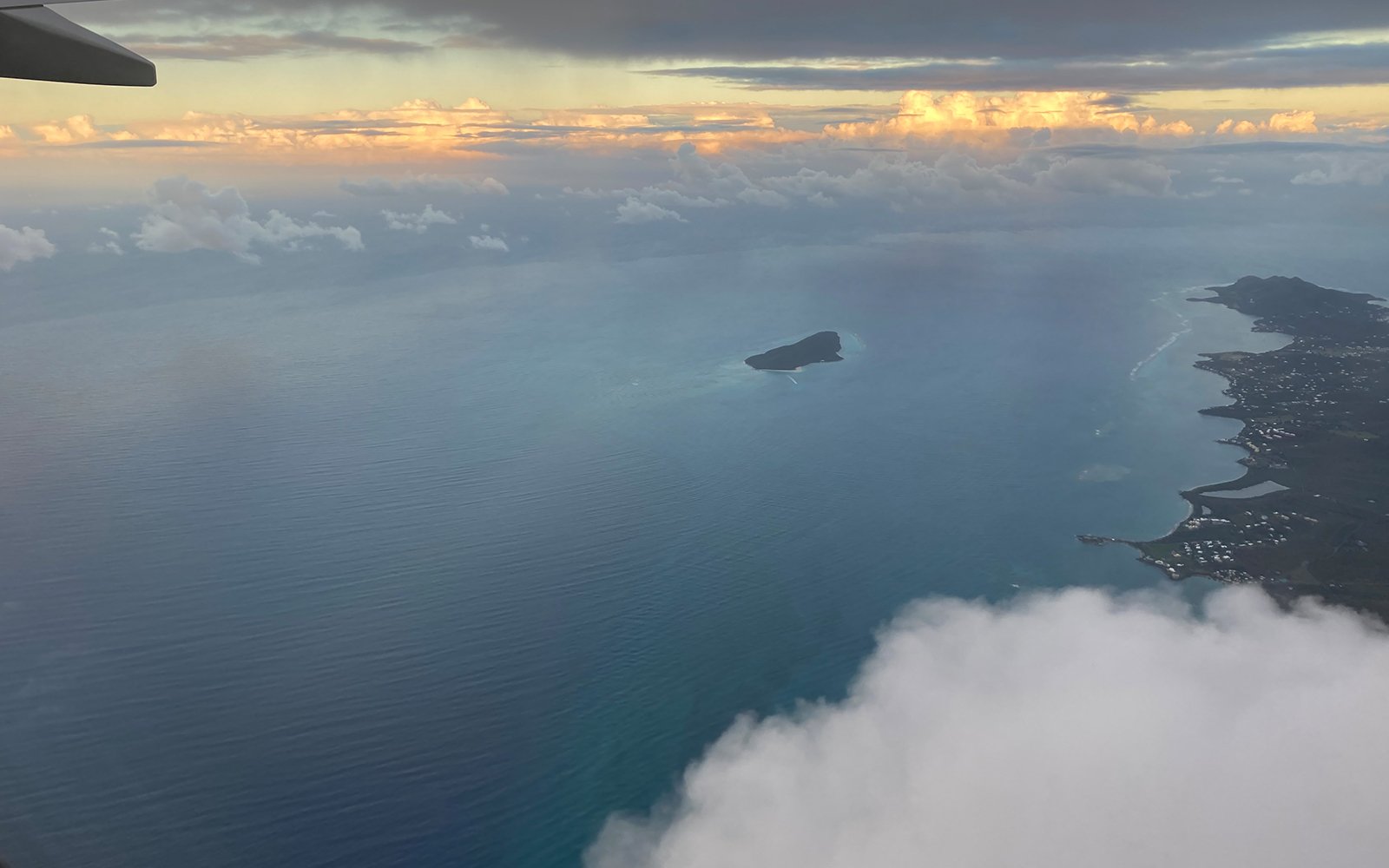View of cloud and ocean from airplane