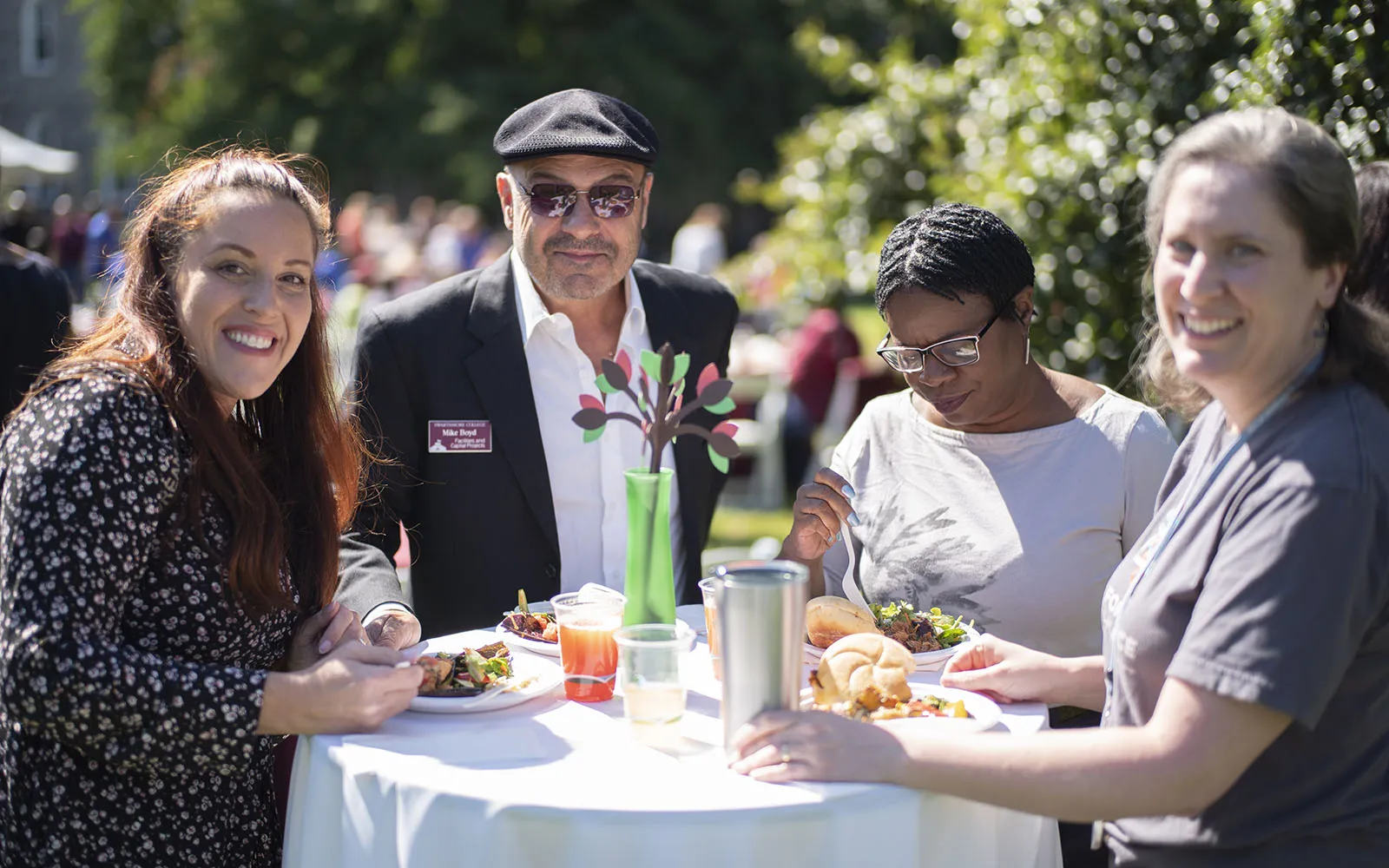 four people standing at table