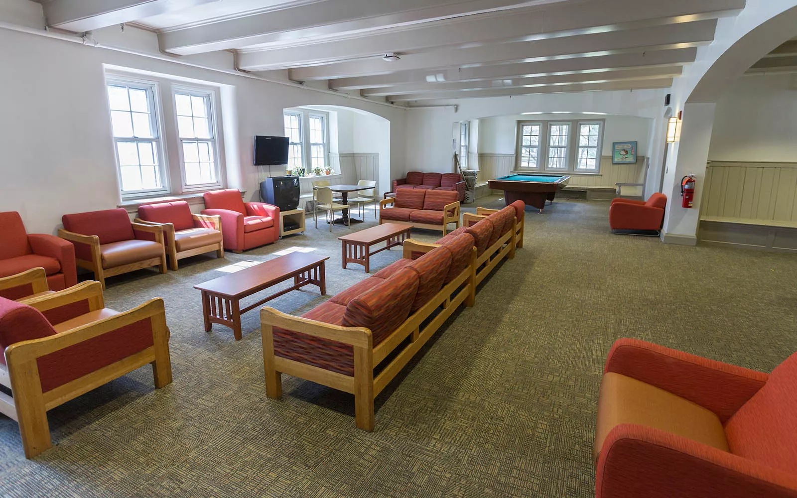 Lounge with red couches and chairs