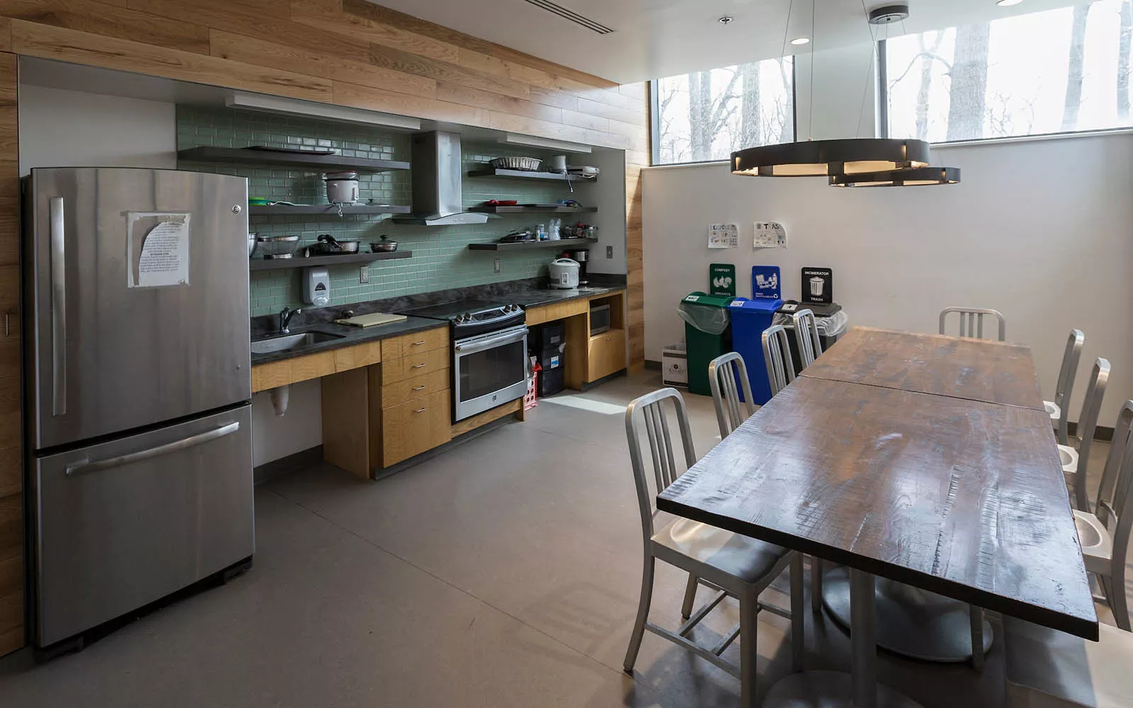 Kitchen space with table, fridge, pots and pans