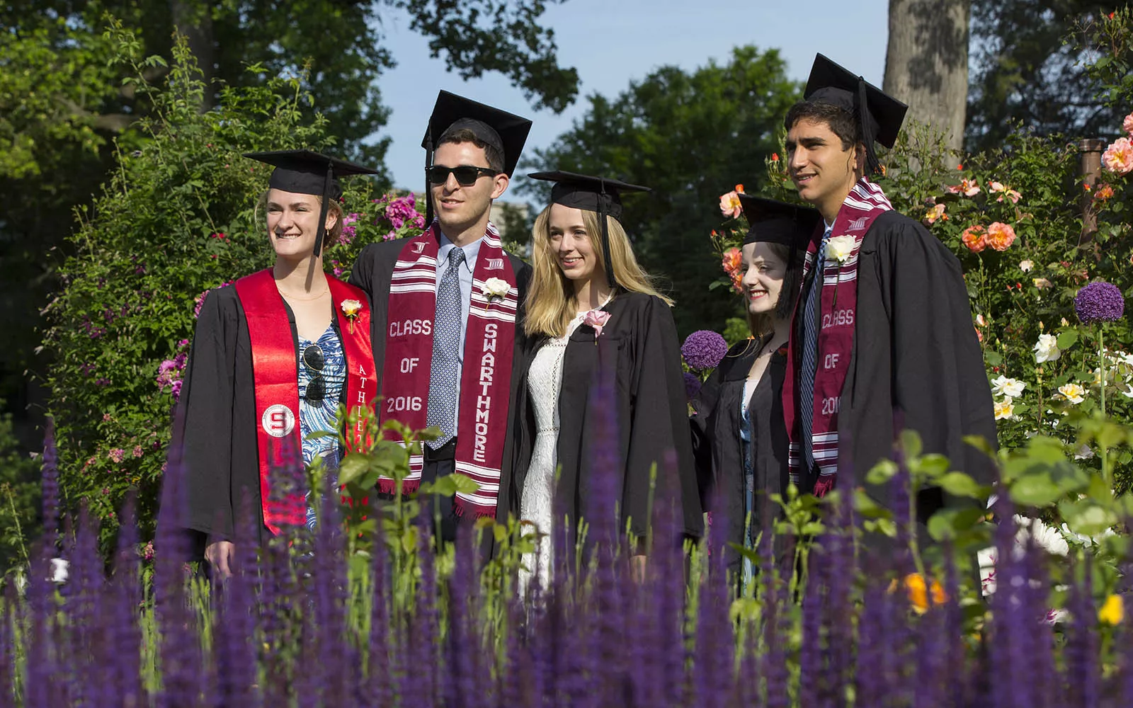 graduates posing in rose garden