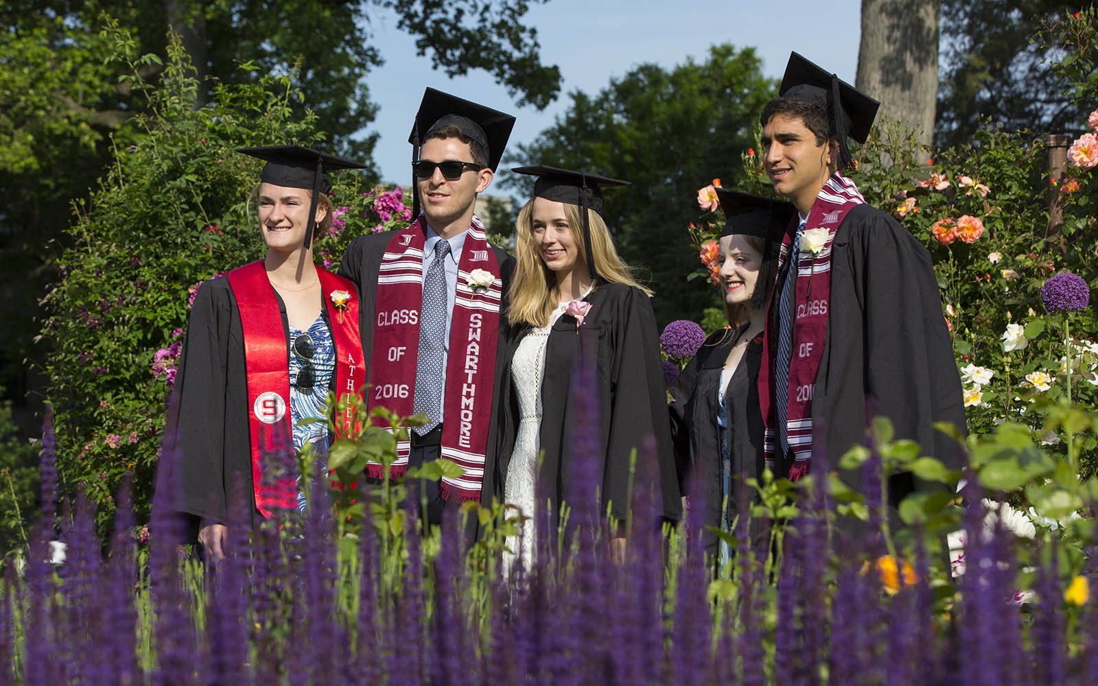 graduates posing in rose garden