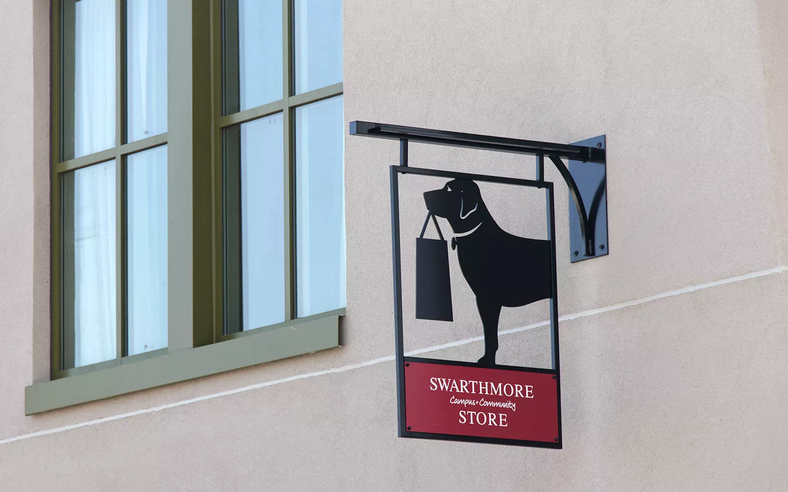 Bookstore sign of dog holding a bag in its mouth