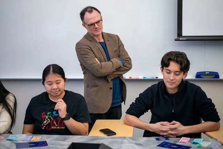 Dominic Tierney watches as students play war games simulation in class