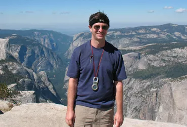 Professor Rablen standing with arid mountain range in the background