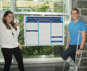 Raundi Quevedo '16 and Josh Turek-Herman '16 standing in front of their project poster