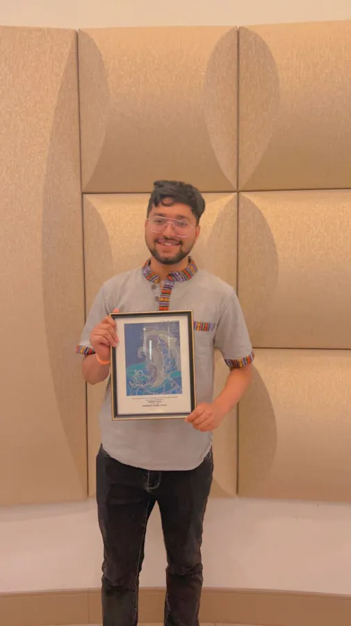 Aashish Panta poses with his award