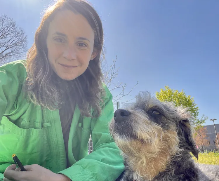 Jody Joyner outdoors with her dog who is looking up at her adoringly