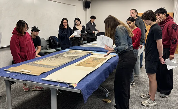 students examine prints from the College Art Collection