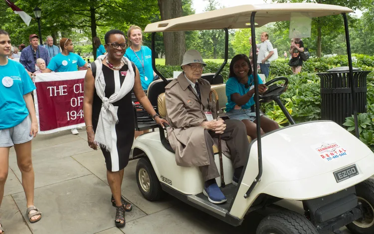 Student drives golf cart during alumni weekend