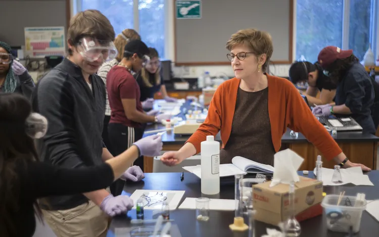 Students with instructor in chemistry lab
