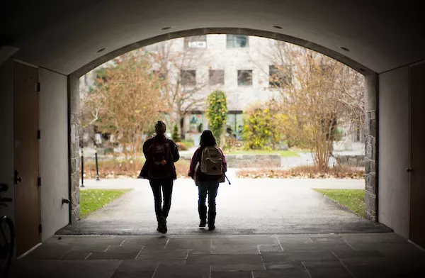 two students walking through Kohlberg breezeway