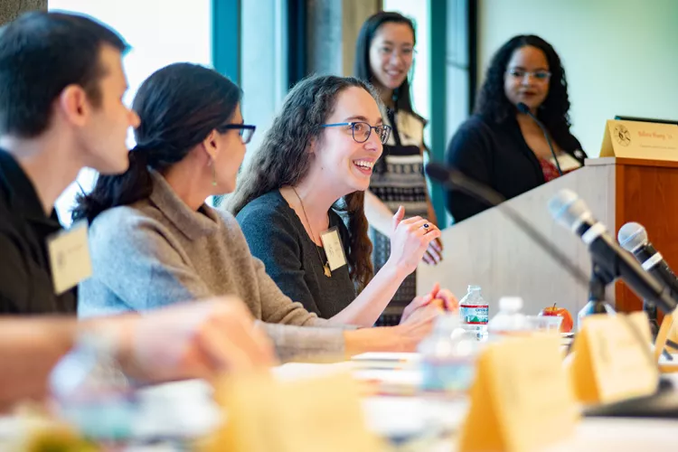 Alumni at panel table speak to crowd