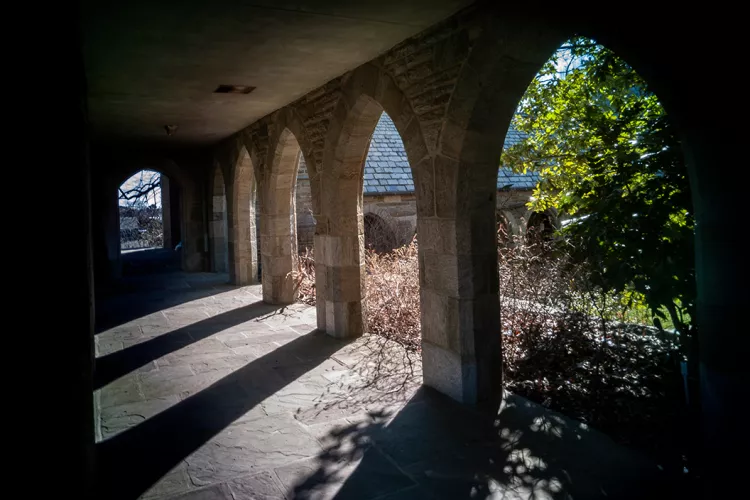 Sunlight passes through arches outside Clothier