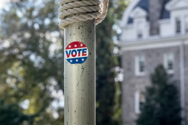 pole with sticker that says "vote" on it