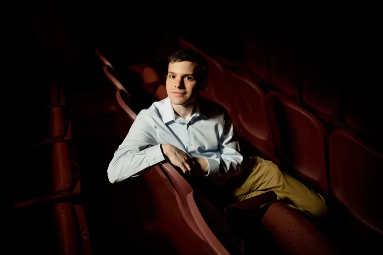 Ben Kapilow sits in dark theater