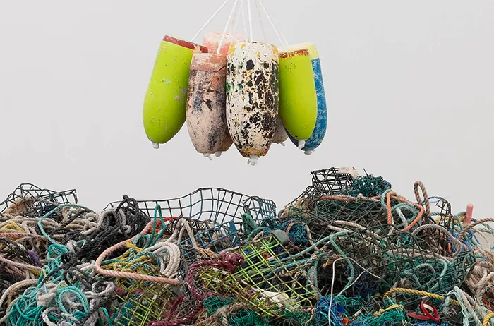 Oxygen canisters lifted above pile of nets