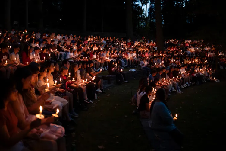 Class of 2027 hold candles during first collection