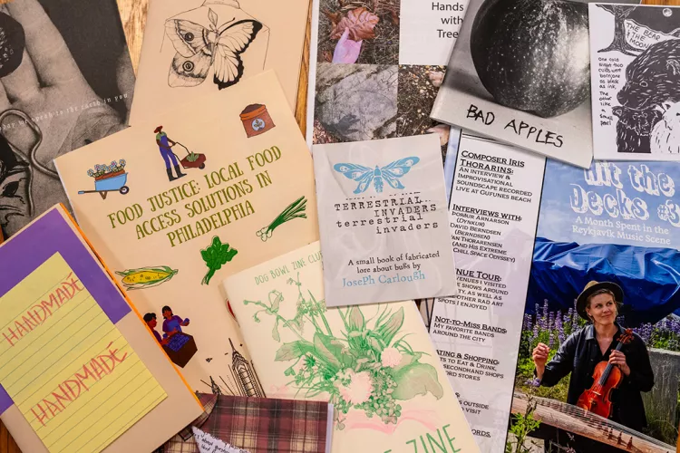 Collection of zines stacked on table