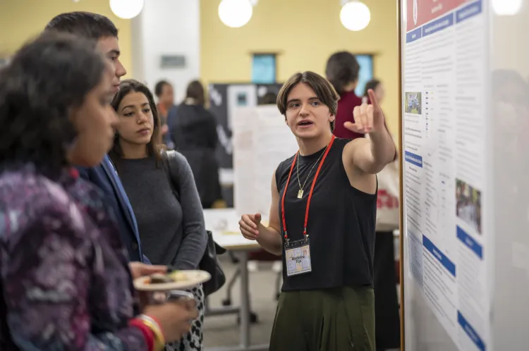 Student presents poster at conference session 