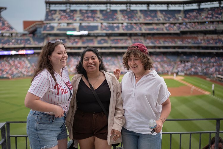 Group of students pose in Citizen's Bank Park at Phillies game