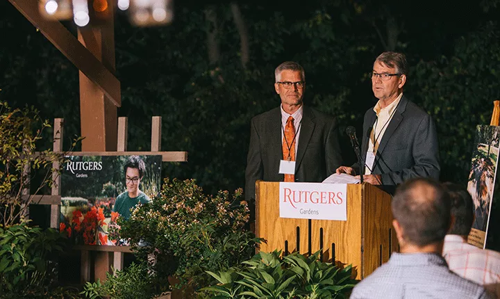 Two men stand at a podium