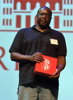 Brett Day with award at winter gathering
