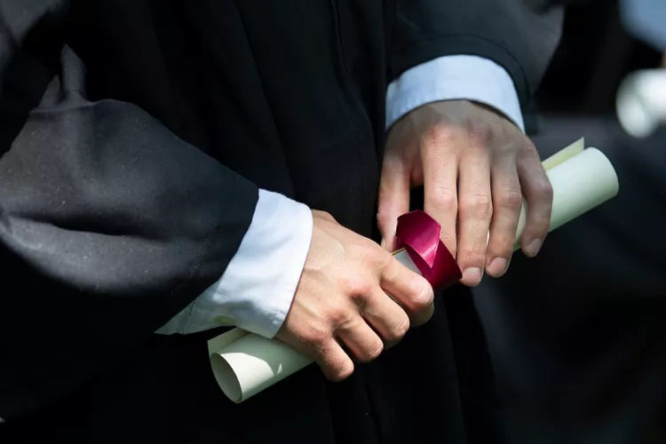 Diploma in hands of student
