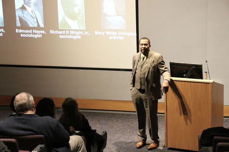 Aldon Morris speaks in front of screen in Lang Performing Arts Center