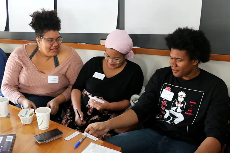 Three students sitting at a table