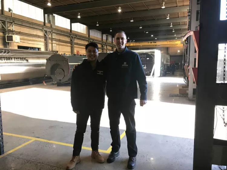Eugene Prymak '13 and William Huang '23 in warehouse